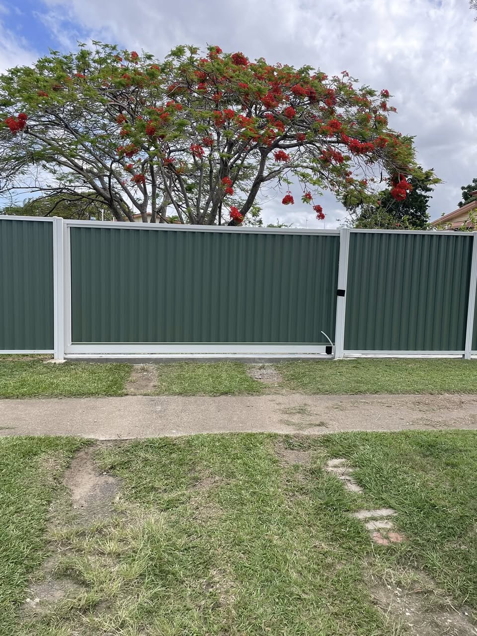Green colorbond automatic sliding gate - full privacy gate