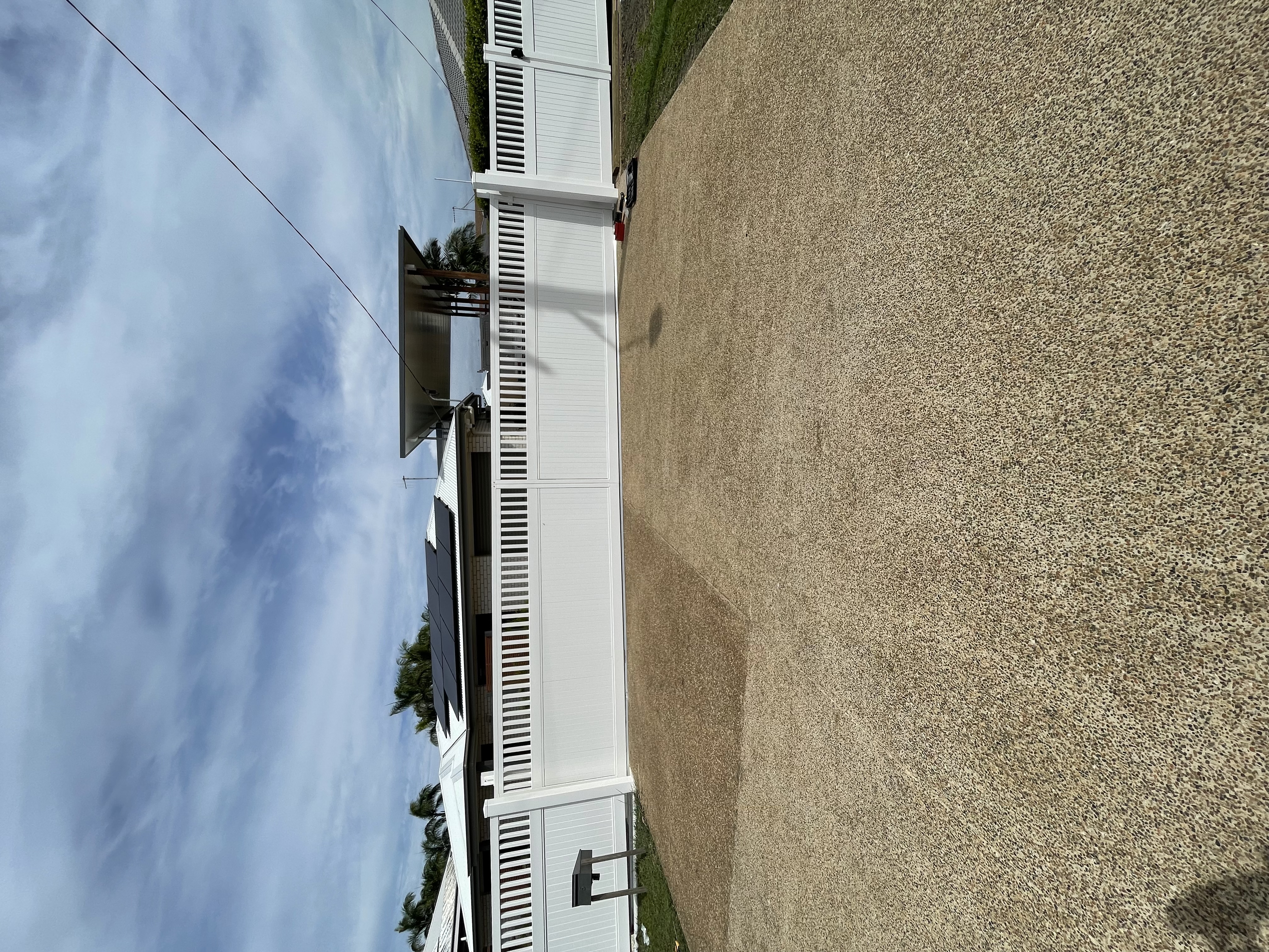 White Hamptons style aluminium sliding gate with louvered slats - custom build by Coastal Automation Bundaberg