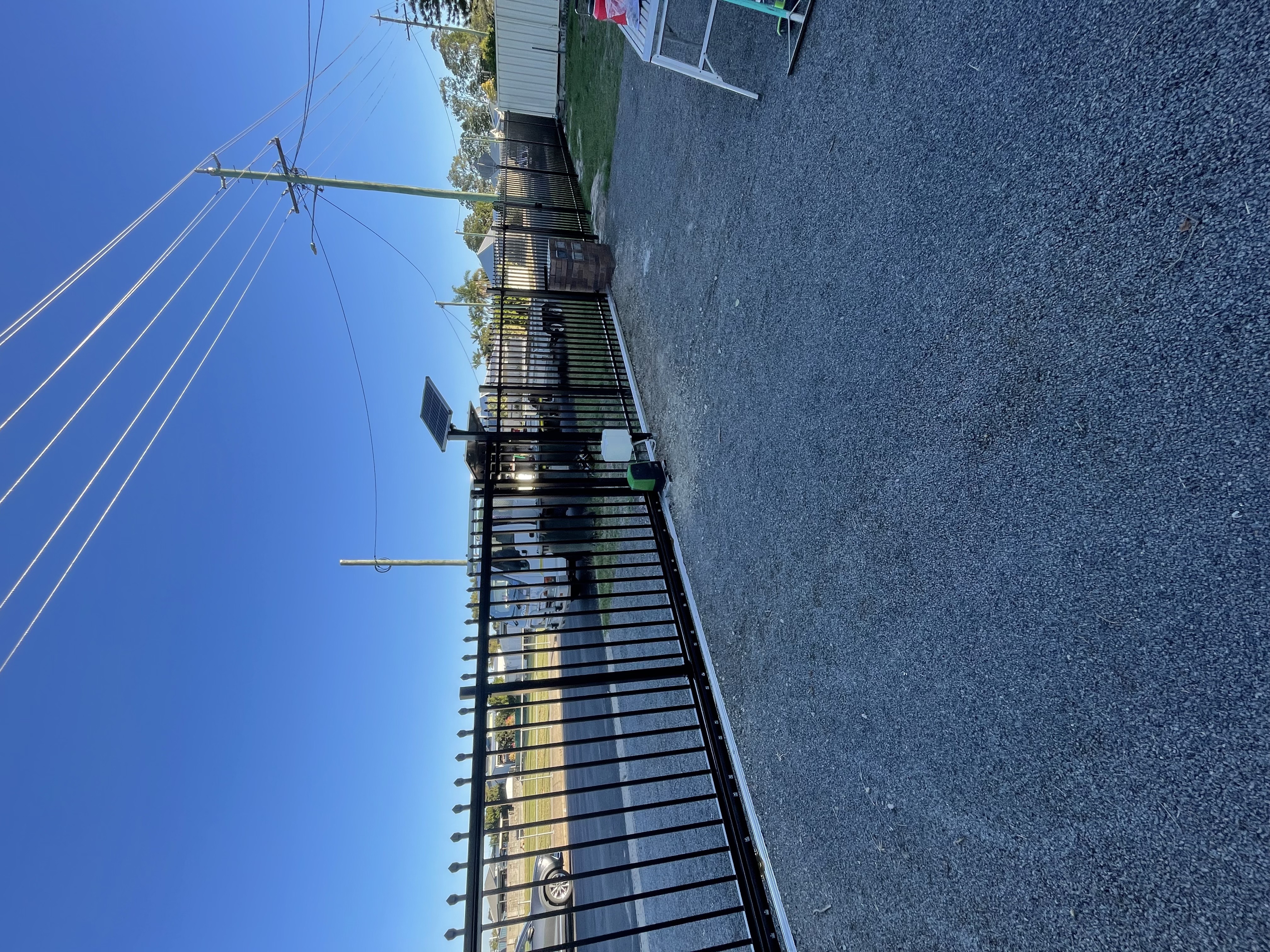 Black spear top security fence with matching automatic gate - unit block install in Bundaberg by Coastal Automation